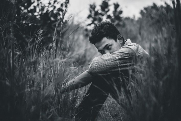 Monochrome Photo Of Man Sitting On Grass